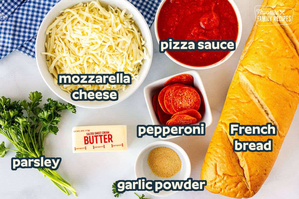 Ingredients to make French Bread Pizza including mozzarella cheese, tomato sauce, pepperoni, French bread, garlic powder, butter and parsley.