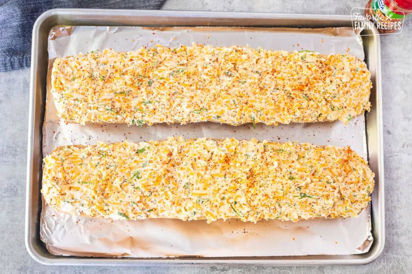 Salad Supreme seasoning on top of unbaked garlic bread with spread.