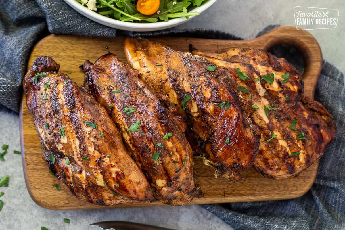 Grilled balsamic chicken on a cutting board.