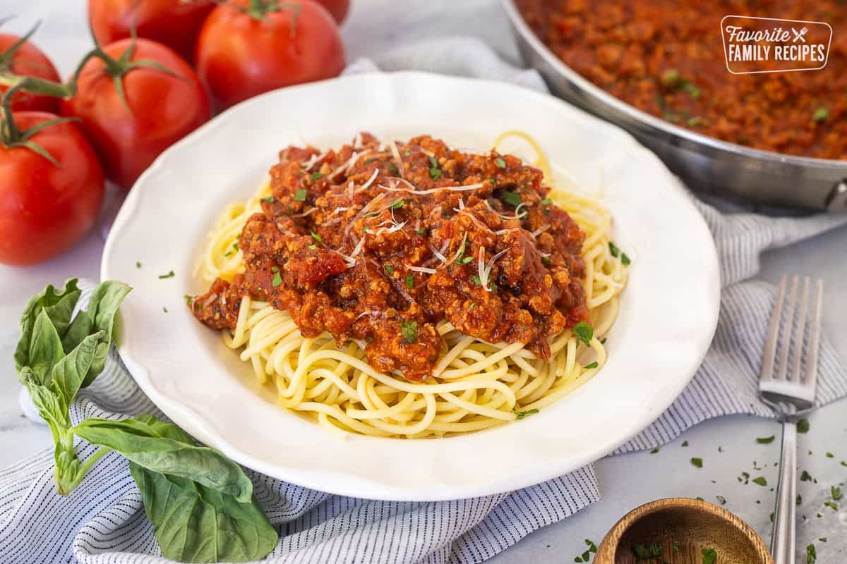 Ground turkey spaghetti on a plate with pasta topped with sauce.