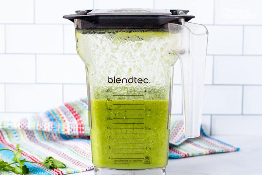 Blender with green sauce.