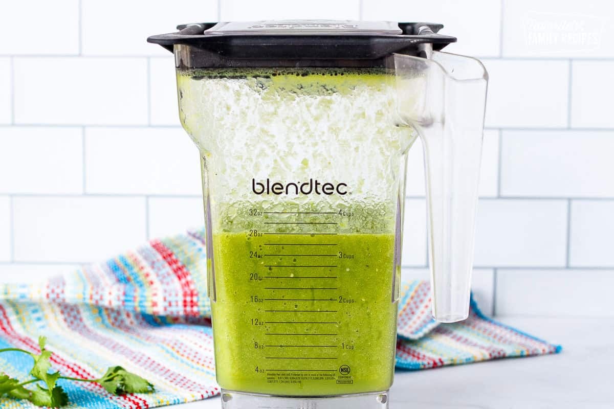 Blender with green sauce.