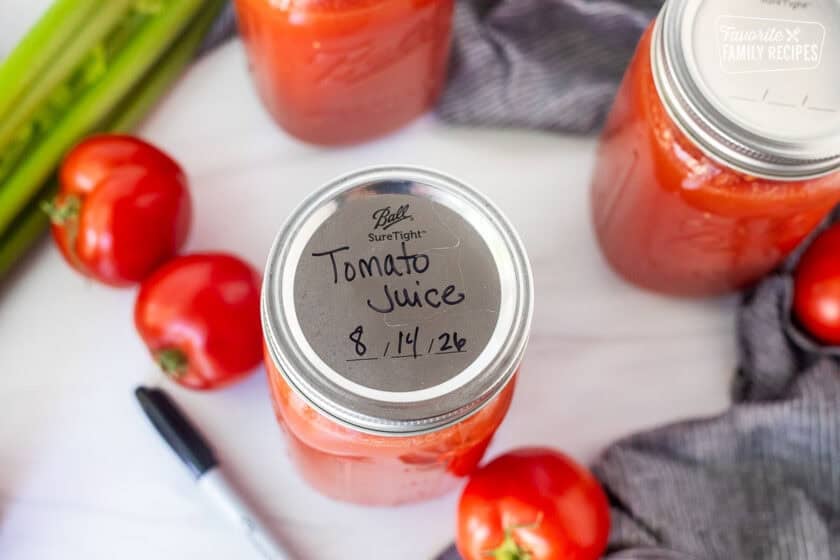 Canned tomato juice labeled on the lid on the canning jar with date.
