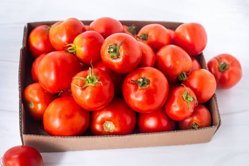 Box of fresh garden tomatoes.