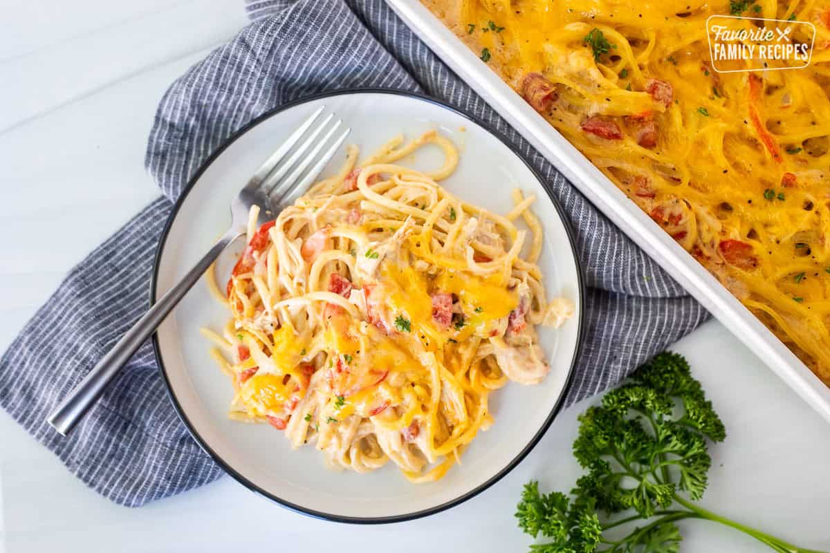 Plate with chicken spaghetti casserole with fork.