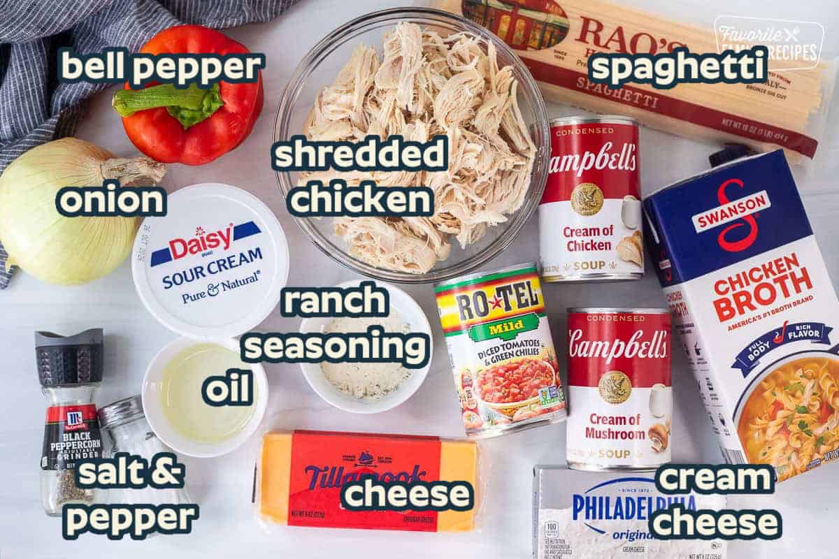 Ingredients to make chicken spaghetti casserole including spaghetti noodles, chicken broth, cream of chicken soup, cream of mushroom soup, cream cheese, Rotel diced tomatoes, sharp cheddar, ranch seasoning, shredded chicken, sour cream, onion, red bell pepper, oil, pepper and salt.