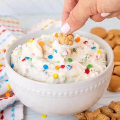 Dipping a teddy graham into a bowl of Dunkaroo dip.