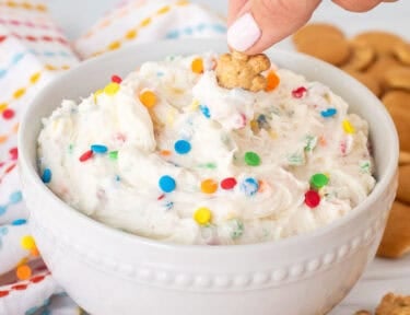 Dipping a teddy graham into a bowl of Dunkaroo dip.