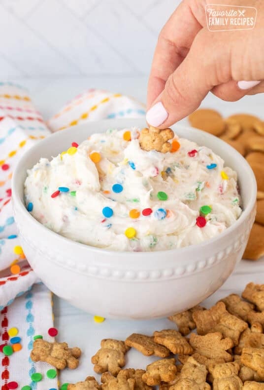 Dipping a teddy graham into a bowl of Dunkaroo dip.