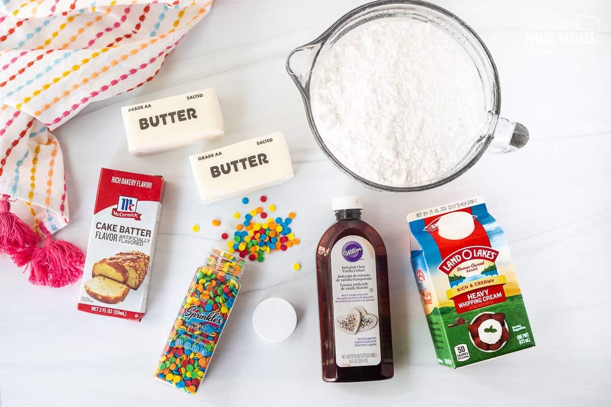 Ingredients to make Dunkaroo Dip including powdered sugar, heavy whipping cream, clear vanilla, butter, cake batter flavor and sprinkles.