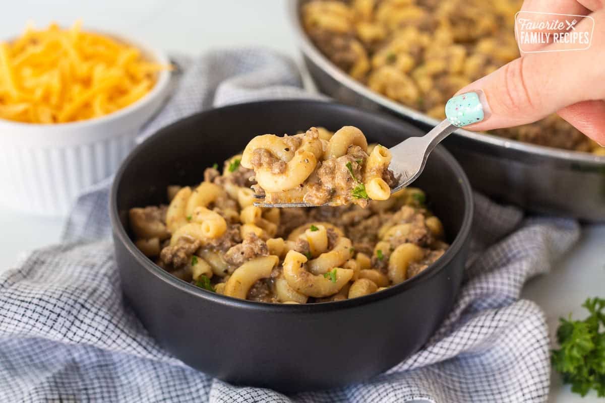 Fork with homemade hamburger helper from bowl.