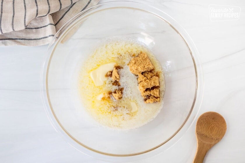 Glass bowl with melted butter and brown sugar.
