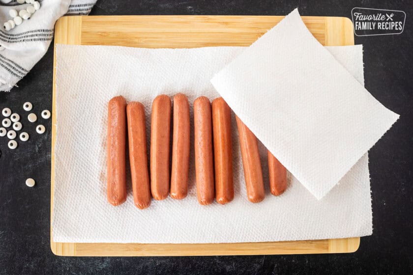 Drying hotdogs with paper towels.