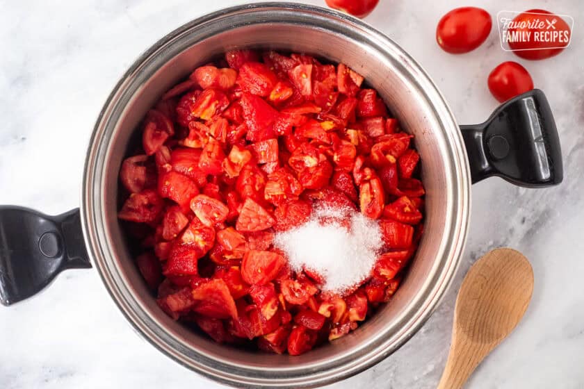 Large pot of cut and diced tomatoes and salt.