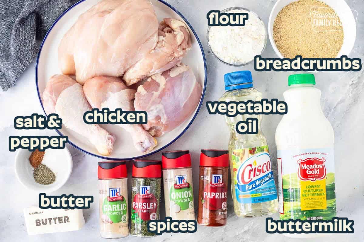 Ingredients to make shake and bake chicken including bread crumbs, buttermilk, vegetable oil, flour, paprika, onion powder, parsley flakes, garlic powder, butter, salt, pepper, cayenne pepper and assortment of chicken pieces.