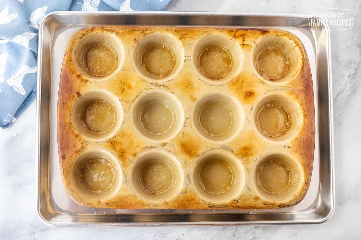 Muffin pan sprayed with nonstick cooking spray in a cookie sheet.