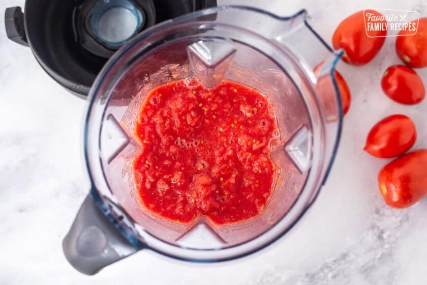 Blender with blended Roma tomatoes.