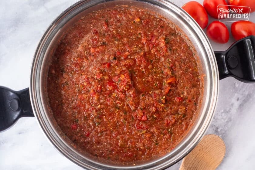 Large pot of combined ingredients to make sweet canned salsa.