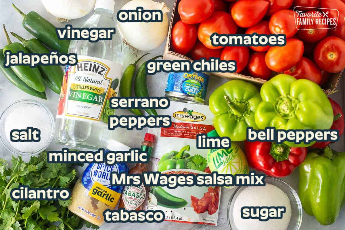 Ingredients to make sweet canned salsa including Roma tomatoes, green bell peppers, red bell peppers, lime juice, sugar, salt, minced garlic, tabasco, Mrs. Wages salsa mix, Serrano peppers, white onions, jalapeños, cilantro, vinegar and mild diced chilies.
