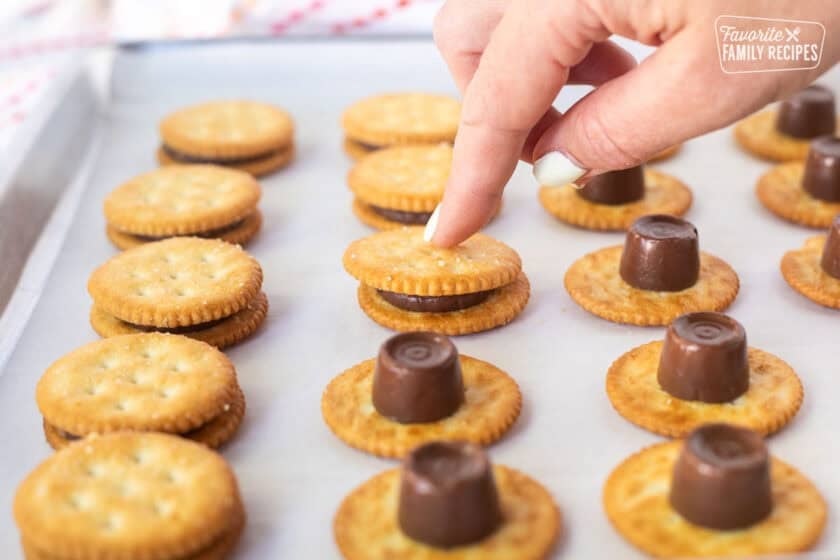 Pressing down melted Rolos between two Ritz crackers.