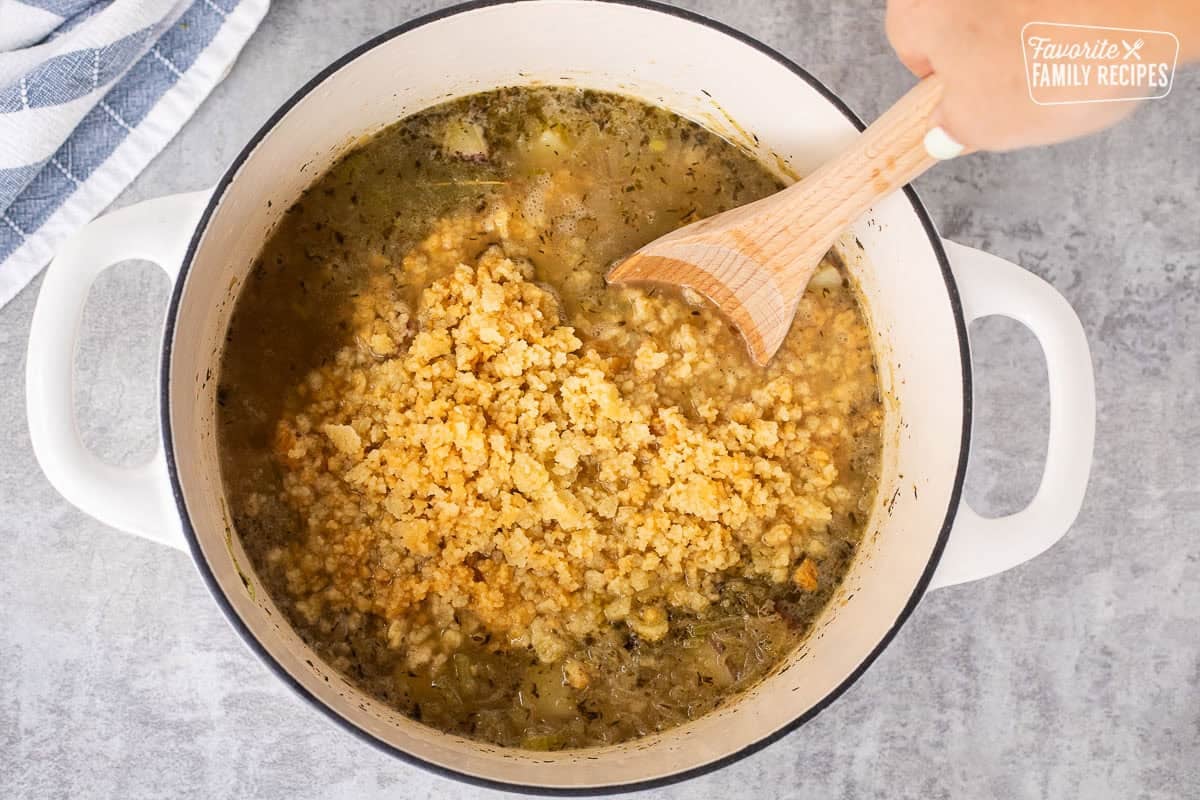Mixing in the butter flour crumble into pot of clam chowder base.