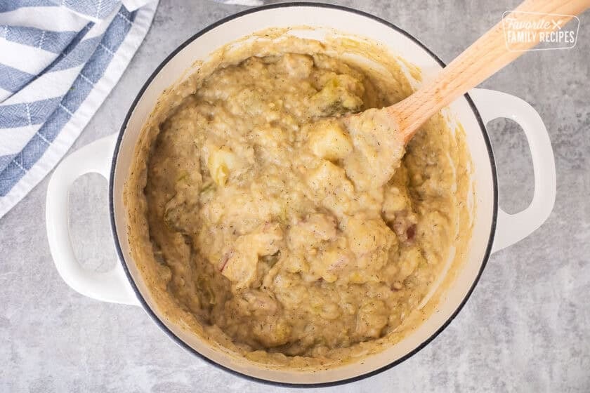 Thick clam chowder mixture in a pot.