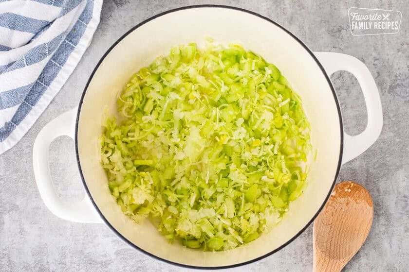 Dutch oven pot with cooked celery, onions and leeks.