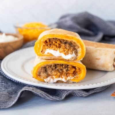 Two halves of a copycat quesarito stacked on top of each other on a plate.