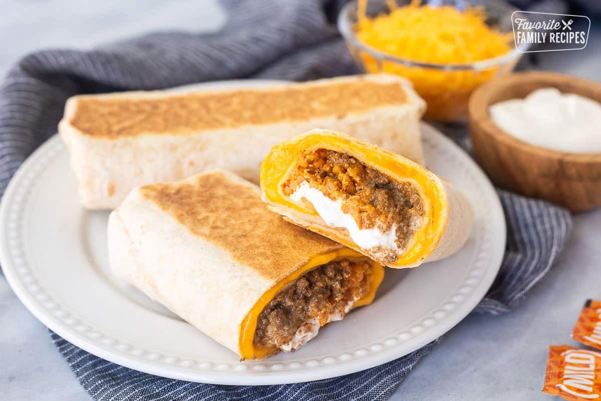 Cut copycat quesarito on a plate next to a full quesarito.