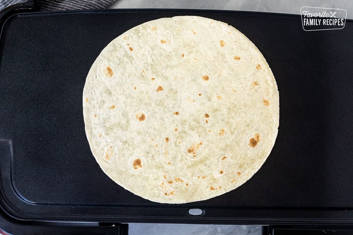 Skillet with burrito size tortilla.