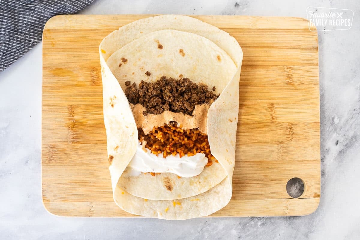 Rolling up the two sides of the quesarito.