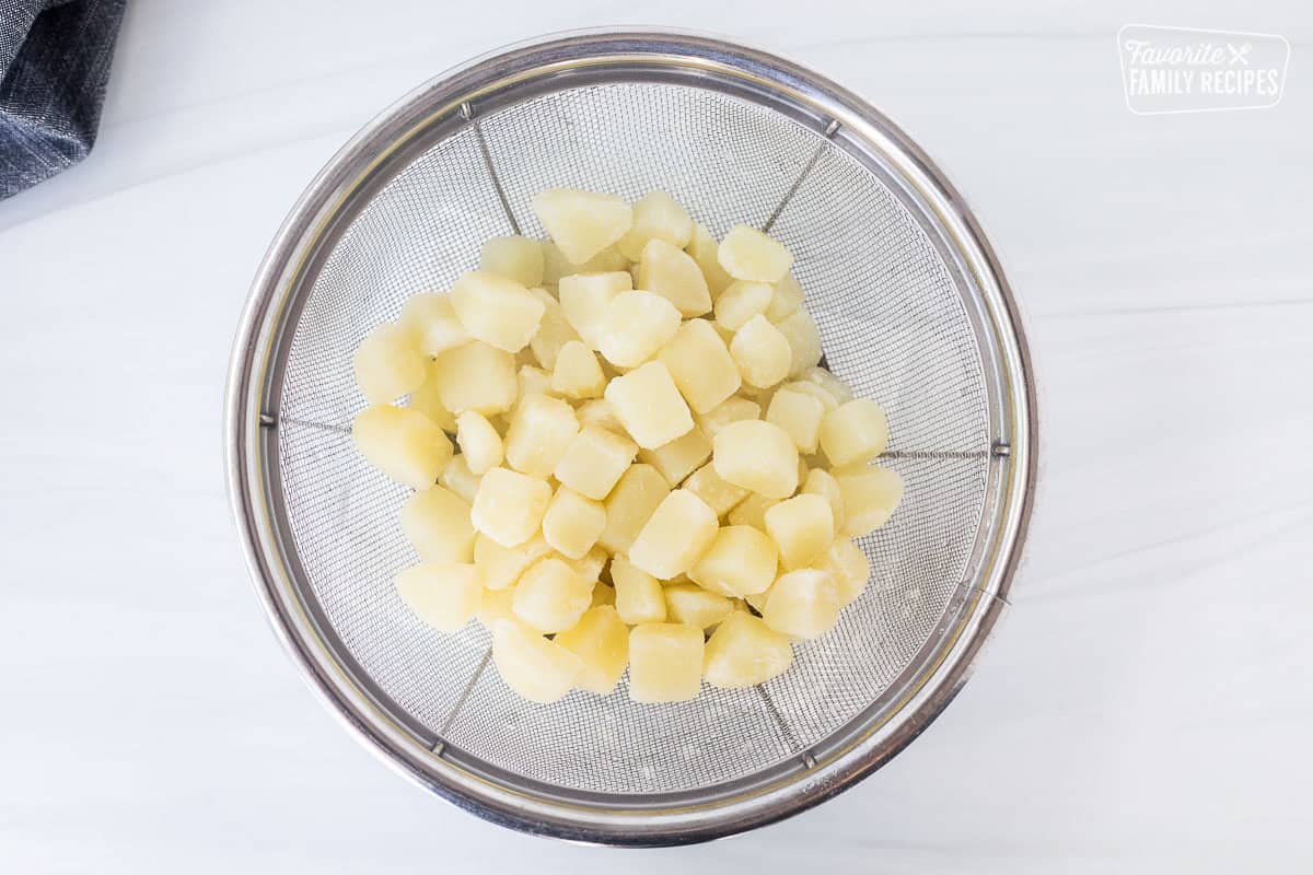 Potatoes draining in a colander to make corn chowder