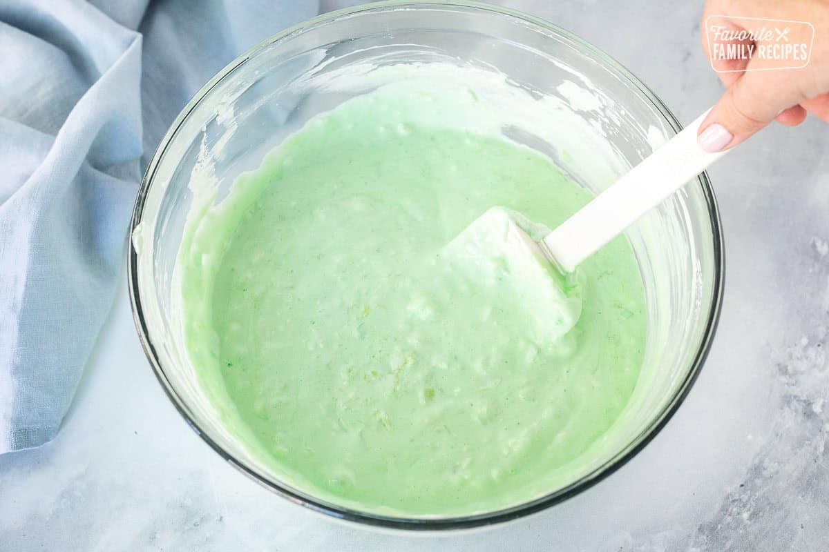 Large mixing bowl with lime jello combined with Cool whip.