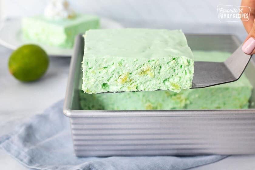 Spatula with a cut piece of lime Jello salad.