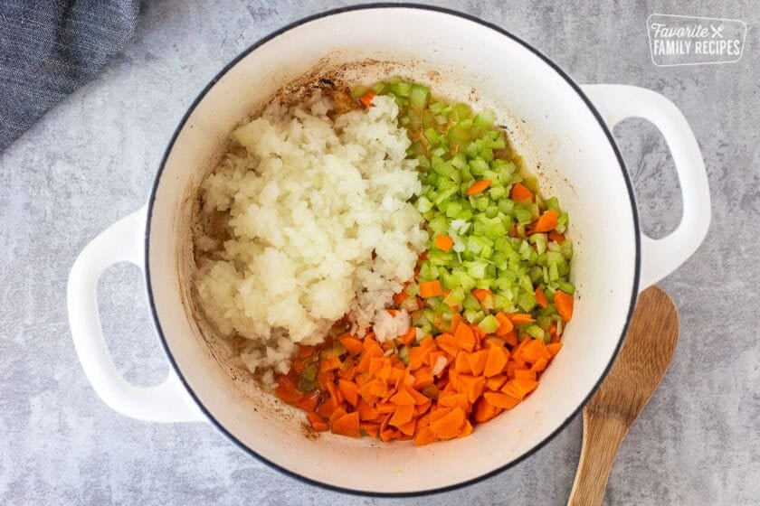 Dutch oven with celery, carrots and onion cooking.