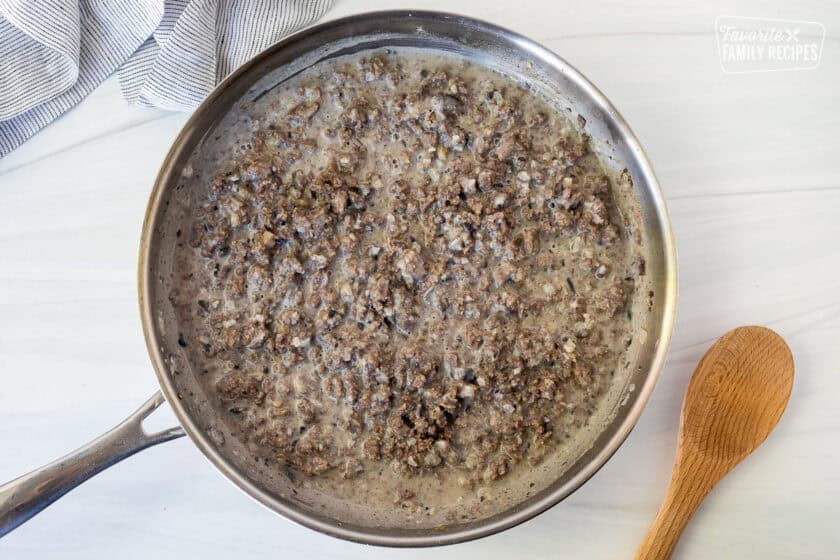 Skillet with ground beef gravy mixture.