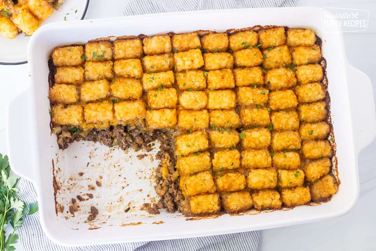 Tater tot casserole dish with ground beef, green beans, cheddar cheese and golden tater tots.