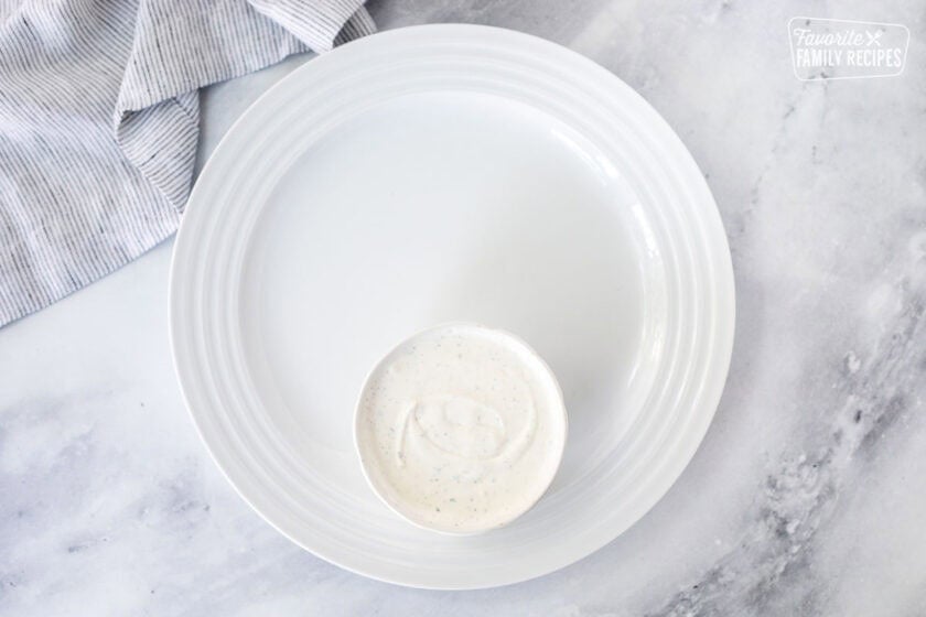 Large round plate with small bowl of Ranch dip.