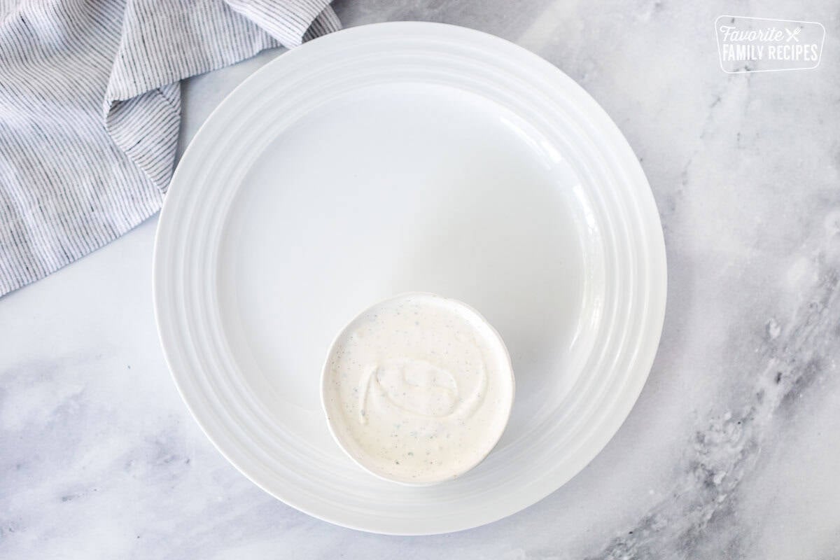 Large round plate with small bowl of Ranch dip.