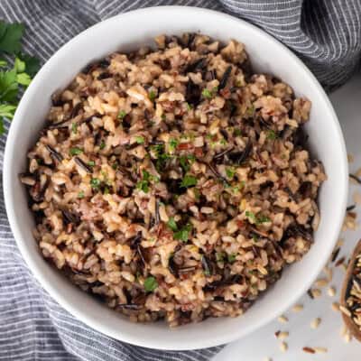 Wild rice and a bowl garnished with parsley.