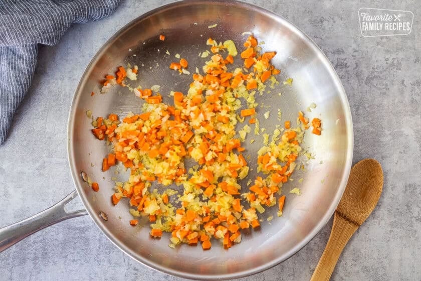 Skillet with cooked onion and carrot.